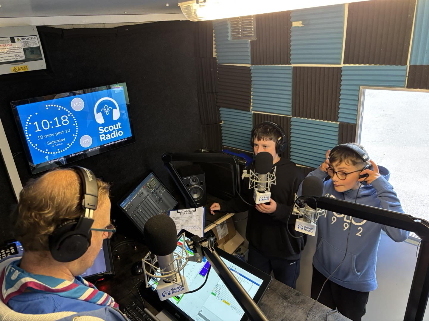 Scout Radio presenters and young people broadcasting from the studio